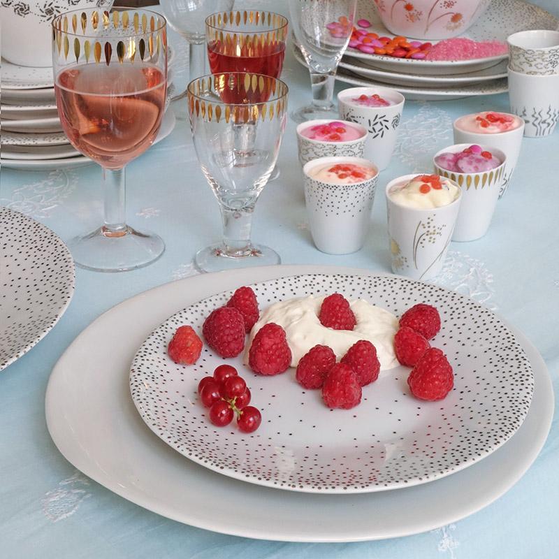 framboises à la crème sur assiette en porcelaine de forme irrégulière blanche à pois argentés - tsé tsé