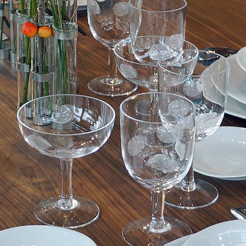 verres à vin et champagne avec des traces de doigt gravées dans le verre sur une table en bois - tsé tsé